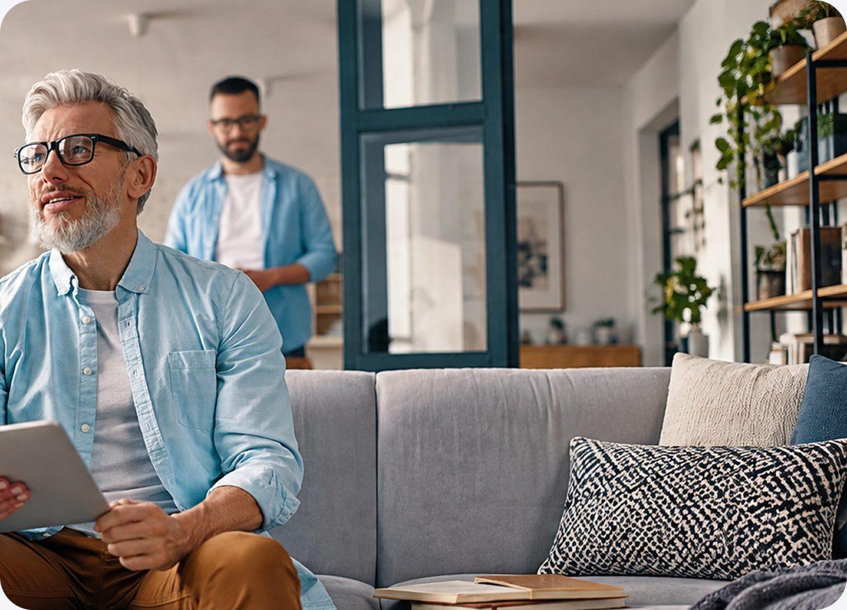 Hombre con su tablet en el living, revisando cuánto puede comprar